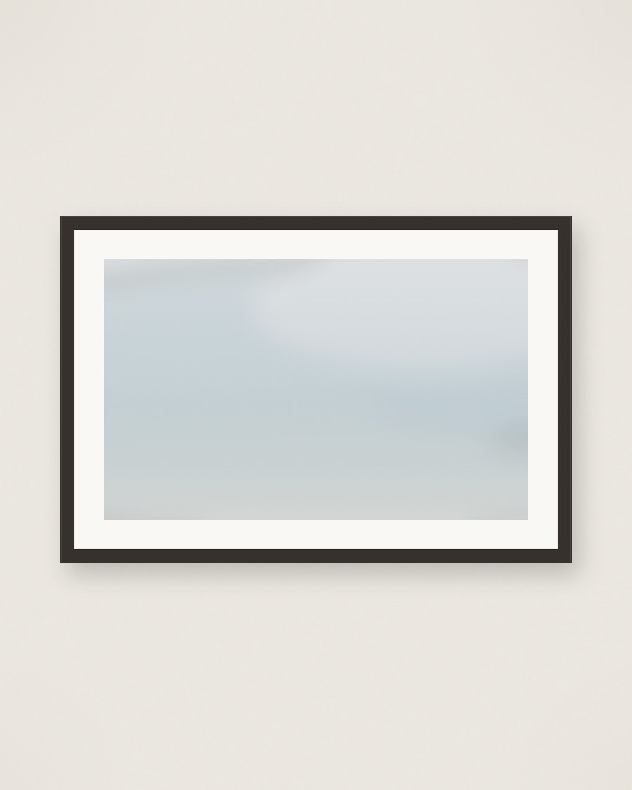 Framed pale mist-blue atmospheric wash, charcoal frame and cream mat